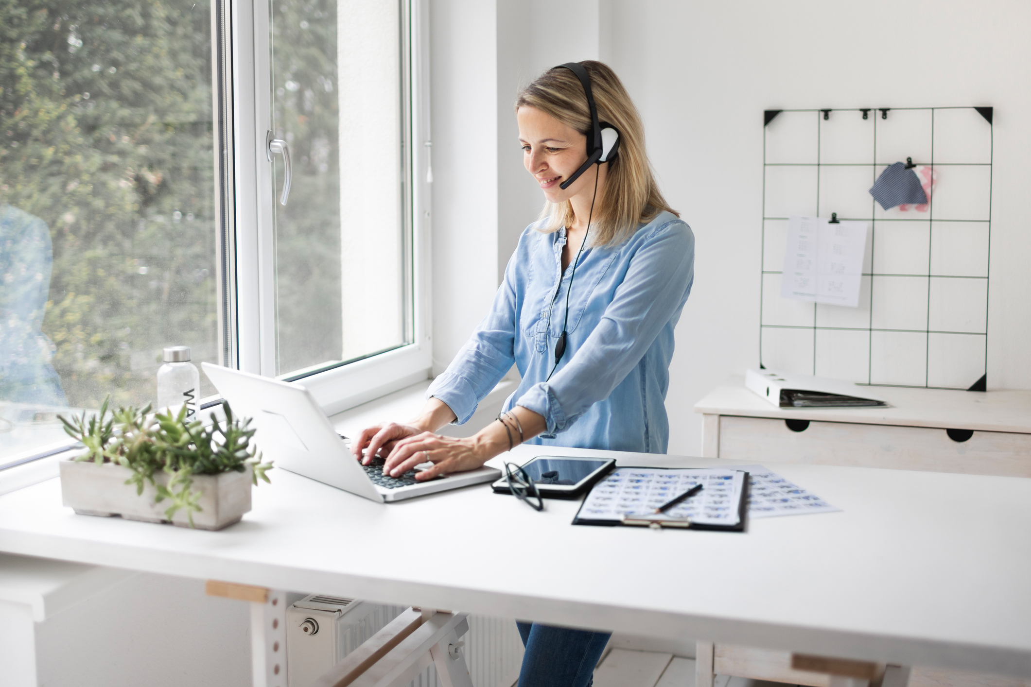 Woman at keyboard with headphones