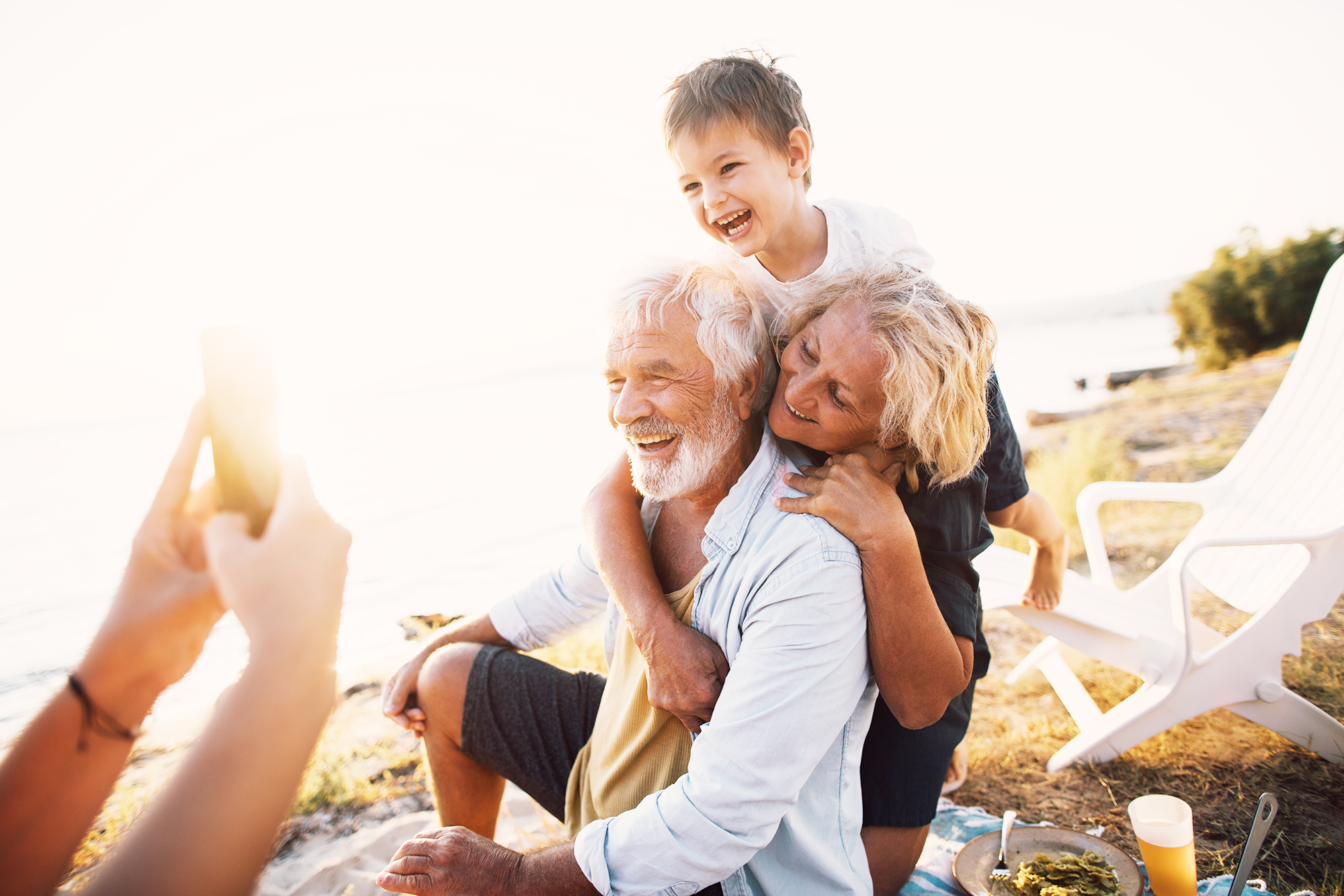Retired couple on beach with grandchild