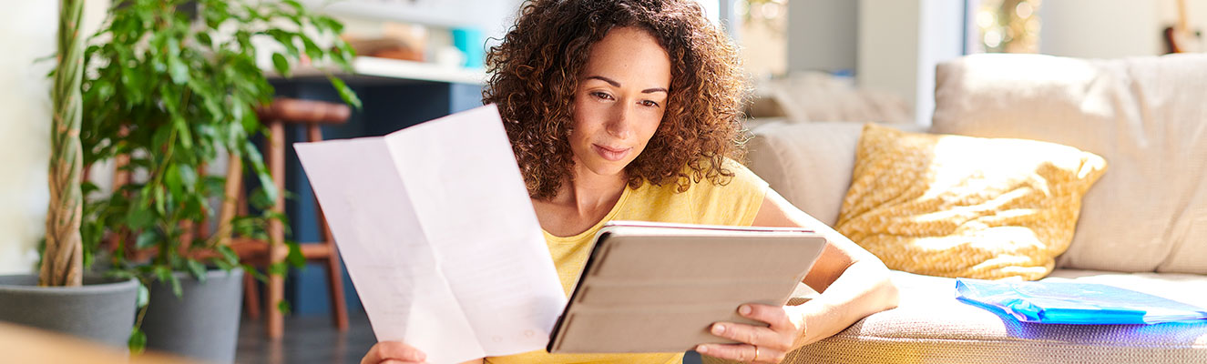 Woman sitting down looking at her ipad